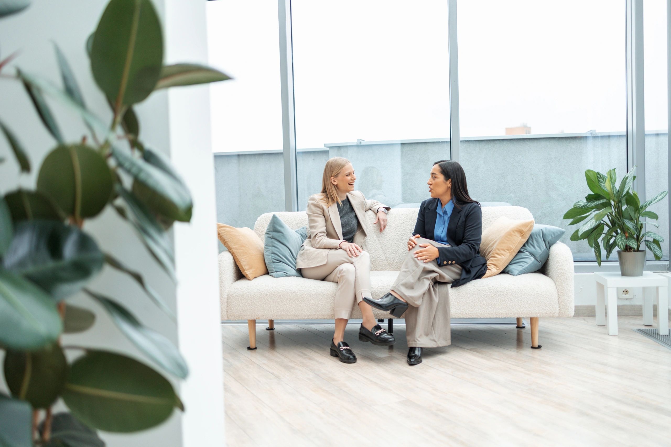 Two professionals discussing strategy in a modern office